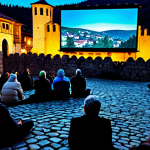 A diverse group of professional, fully clothed individuals, including filmmakers and attendees, engaged in an outdoor film screening in historic Prizren, Kosovo. Ancient city walls are subtly illuminated by cinematic projections, reflecting on cobblestone streets. A large, open-air screen is visible under a blanket of stars, with hints of repurposed Ottoman-era architecture in the background. The atmosphere is vibrant, magical, and captures authentic storytelling. Safe for work, appropriate content, fully clothed, professional. Perfect anatomy, correct proportions, natural pose, well-formed hands, proper finger count, natural body proportions, high quality.